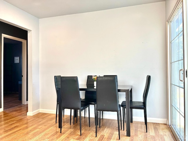 dining area with wood finished floors and baseboards