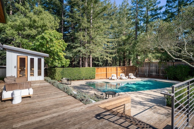421 Crown Rd, Kentfield, CA 94904 - view of pool with a wooden deck, a fenced backyard, view of wooded area, and an outdoor structure