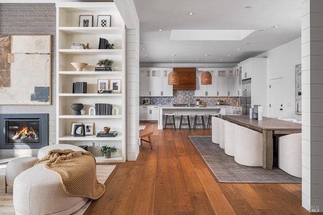421 Crown Rd, Kentfield, CA 94904 - living area with a skylight, dark wood-style flooring, a large fireplace, and recessed lighting