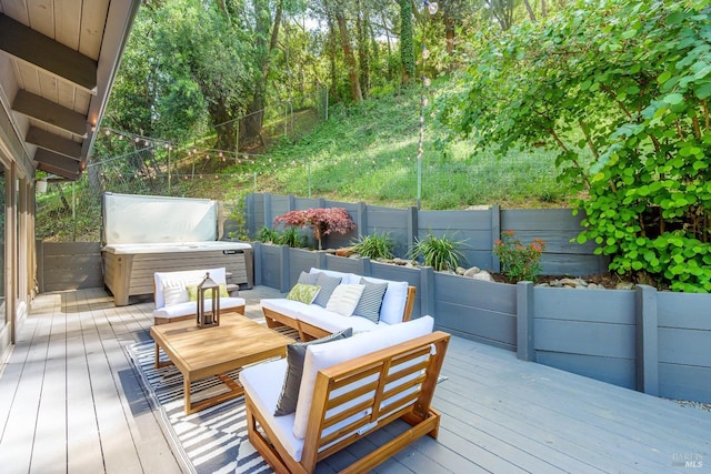 wooden deck featuring a hot tub, an outdoor hangout area, and a fenced backyard