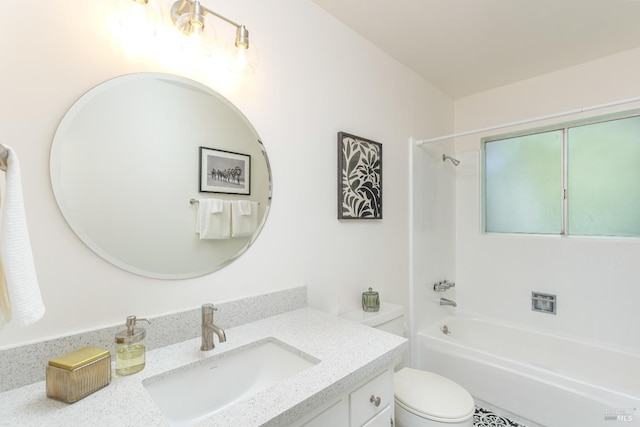 bathroom with vanity, shower / bath combination, and toilet