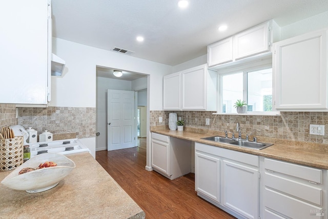 2095 W Pueblo Ave Unit A, Napa, CA 94558 - kitchen featuring a sink, dark wood-type flooring, backsplash, white cabinetry, and light countertops
