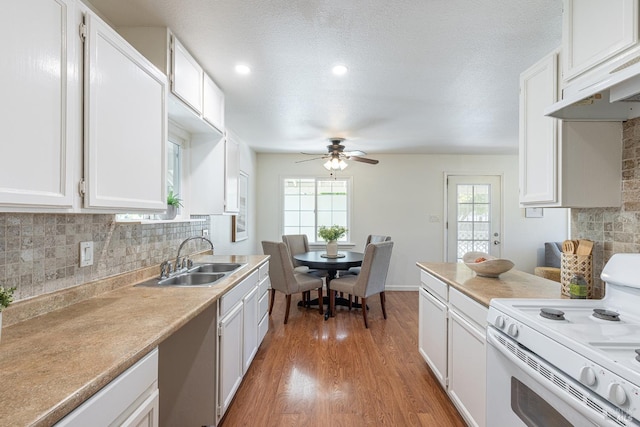 2095 W Pueblo Ave Unit A, Napa, CA 94558 - kitchen with white electric range, a sink, a ceiling fan, white cabinetry, and light wood-style floors