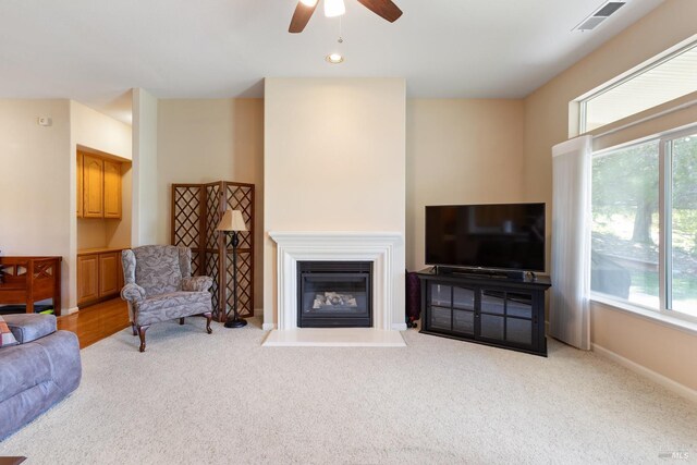 573 Laurel Pl, Rio Vista, CA 94571 - carpeted living room with a ceiling fan, healthy amount of natural light, a glass covered fireplace, and baseboards