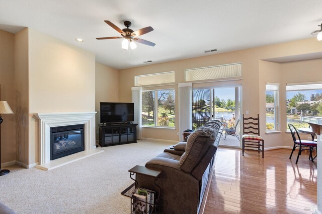 573 Laurel Pl, Rio Vista, CA 94571 - living area featuring baseboards, ceiling fan, a glass covered fireplace, recessed lighting, and wood finished floors