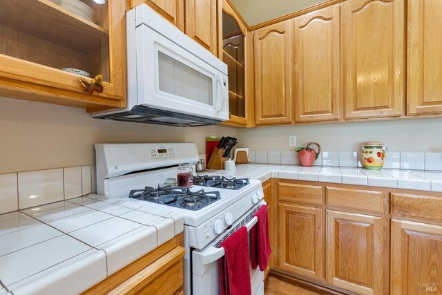 573 Laurel Pl, Rio Vista, CA 94571 - kitchen featuring white appliances, tile counters, glass insert cabinets, and open shelves