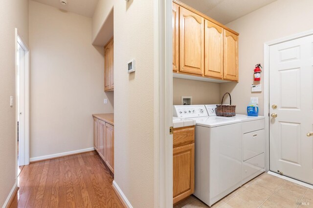 573 Laurel Pl, Rio Vista, CA 94571 - laundry area with cabinet space, washing machine and clothes dryer, light wood-style floors, and baseboards