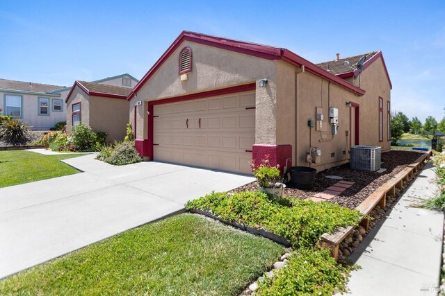 573 Laurel Pl, Rio Vista, CA 94571 - view of front of home featuring a garage, stucco siding, driveway, and central air condition unit