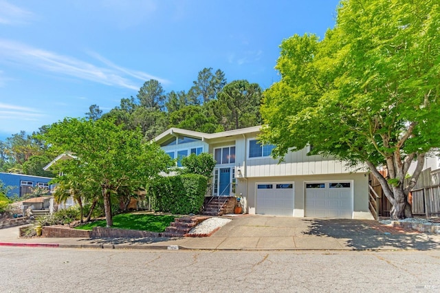 raised ranch featuring driveway and an attached garage