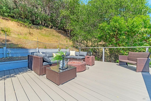 wooden deck with an outdoor living space with a fire pit
