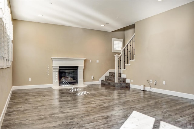 566 Chaparral Loop, Vacaville, CA 95688 - unfurnished living room with a glass covered fireplace, wood finished floors, stairway, recessed lighting, and baseboards