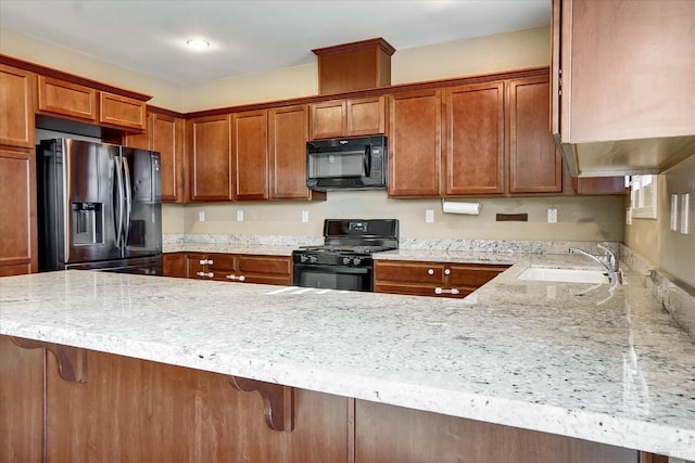 566 Chaparral Loop, Vacaville, CA 95688 - kitchen with black appliances, a sink, a peninsula, brown cabinetry, and a breakfast bar