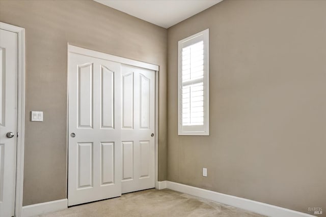 566 Chaparral Loop, Vacaville, CA 95688 - unfurnished bedroom featuring light carpet, baseboards, and a closet