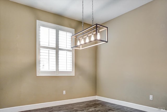 566 Chaparral Loop, Vacaville, CA 95688 - unfurnished dining area featuring baseboards, dark wood-style floors, and a chandelier