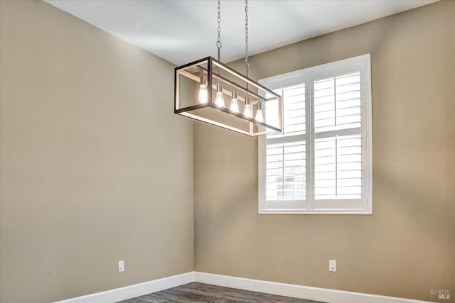 566 Chaparral Loop, Vacaville, CA 95688 - unfurnished dining area featuring plenty of natural light, baseboards, wood finished floors, and a chandelier