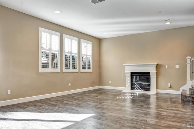 566 Chaparral Loop, Vacaville, CA 95688 - unfurnished living room with wood finished floors, a glass covered fireplace, baseboards, and recessed lighting