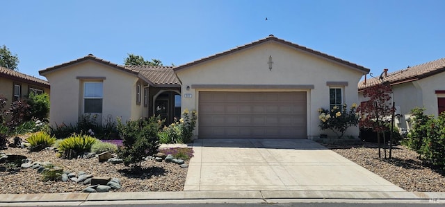 611 Twin Lakes Ln, Rio Vista, CA 94571 - view of front of home with driveway, a garage, stucco siding, and a tiled roof