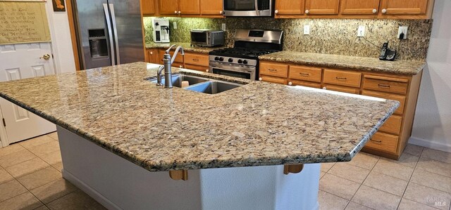 611 Twin Lakes Ln, Rio Vista, CA 94571 - kitchen with appliances with stainless steel finishes, a sink, brown cabinetry, and tasteful backsplash