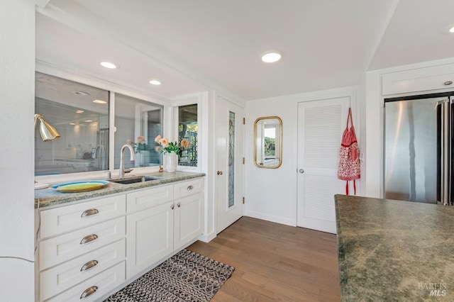 full bath featuring wood finished floors, vanity, baseboards, recessed lighting, and a shower