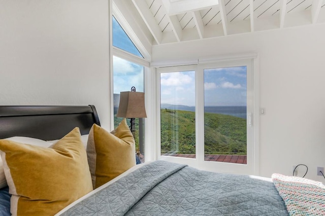 bedroom with beam ceiling and high vaulted ceiling