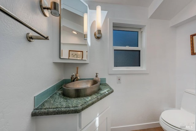 half bathroom with toilet and vanity