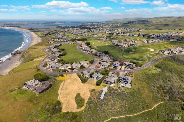 aerial view of property's location featuring a large body of water and nearby suburban area