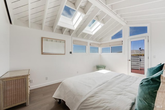 bedroom with wood finished floors, a skylight, baseboards, and access to outside