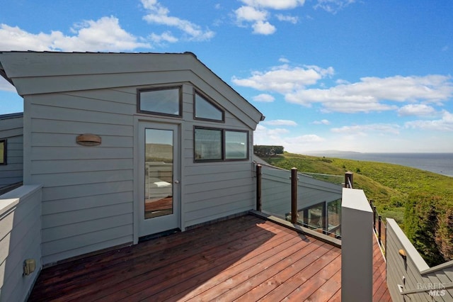 wooden terrace featuring a water view