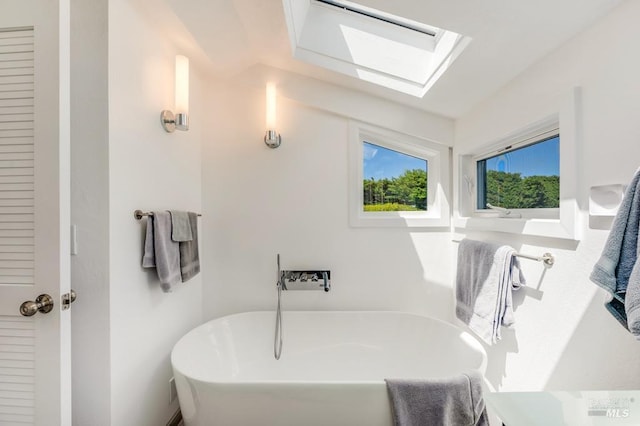 bathroom with a soaking tub