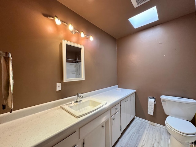 4511 Dry Creek Rd, Napa, CA 94558 - bathroom featuring a skylight, toilet, vanity, wood finished floors, and a shower