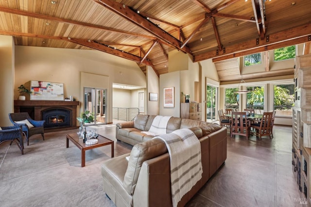 1 Dover Rd, Inverness, CA 94937 - living room featuring a lit fireplace, wood ceiling with exposed beams, concrete floors, high vaulted ceiling, and plenty of natural light