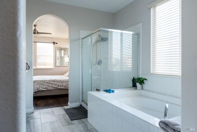 ensuite bathroom featuring a shower stall and a garden tub