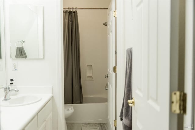 bathroom featuring toilet, vanity, marble finish flooring, and shower / bathtub combination with curtain