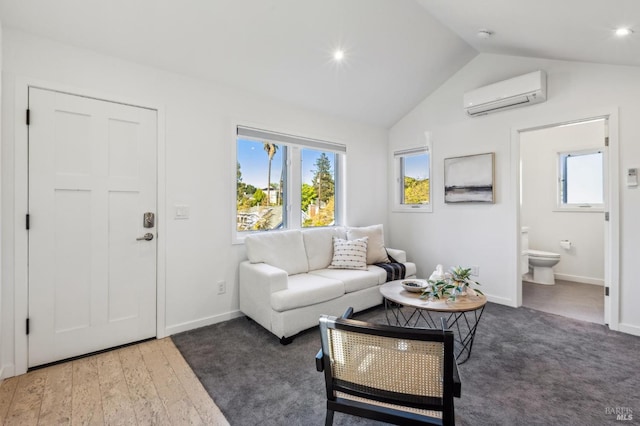 520 Howard St, Petaluma, CA 94952 - living room featuring an AC wall unit, vaulted ceiling, baseboards, and healthy amount of natural light