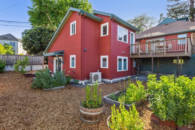 520 Howard St, Petaluma, CA 94952 - rear view of house featuring a vegetable garden, ac unit, a deck, and fence
