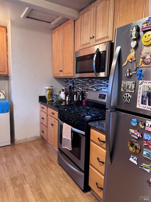 812 Grant St, Vallejo, CA 94590 - kitchen with stainless steel appliances, light wood finished floors, decorative backsplash, dark stone countertops, and baseboards