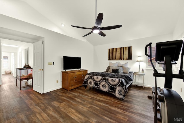 bedroom with vaulted ceiling, dark wood finished floors, baseboards, and ceiling fan