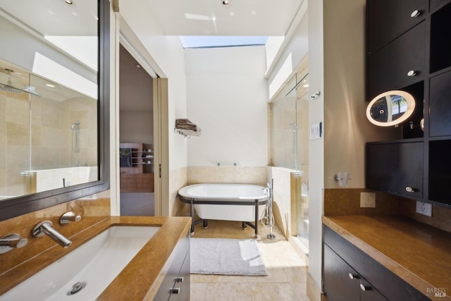 full bathroom with a stall shower, vanity, a soaking tub, and tile patterned flooring