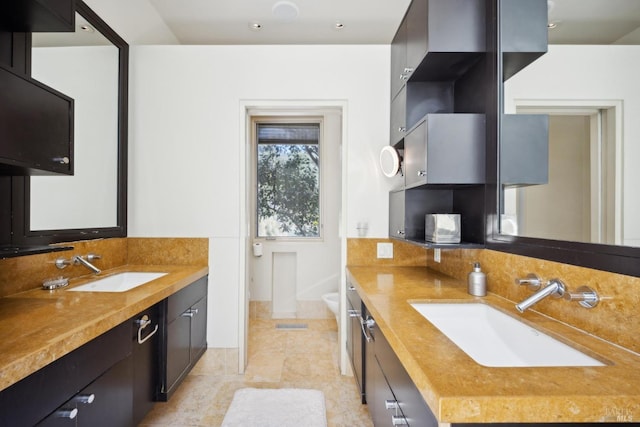 bathroom with two vanities and tile patterned flooring