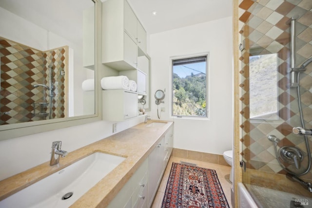 bathroom with a stall shower, double vanity, toilet, and tile patterned floors