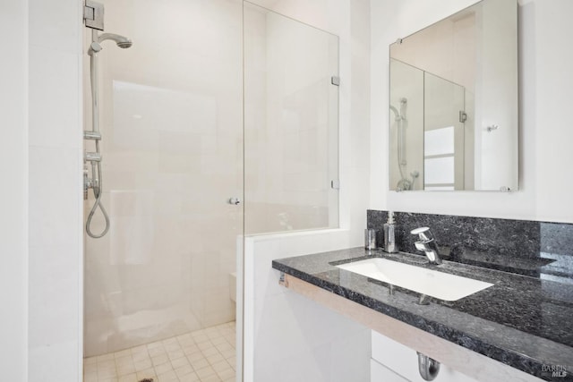 bathroom featuring a sink, a stall shower, and toilet