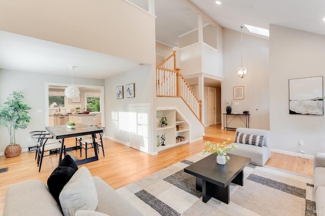 587 El Capitan Dr, Danville, CA 94526 - living area with stairs, light wood-style floors, a high ceiling, baseboards, and recessed lighting