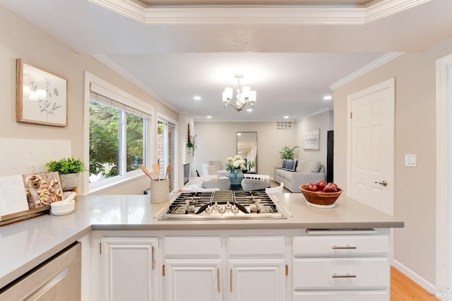 587 El Capitan Dr, Danville, CA 94526 - kitchen with stainless steel gas stovetop, light countertops, crown molding, white cabinetry, and a chandelier