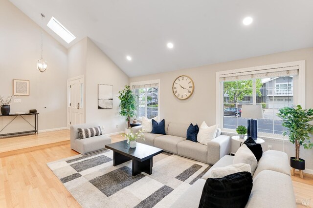 587 El Capitan Dr, Danville, CA 94526 - living room featuring a skylight, wood finished floors, baseboards, high vaulted ceiling, and recessed lighting