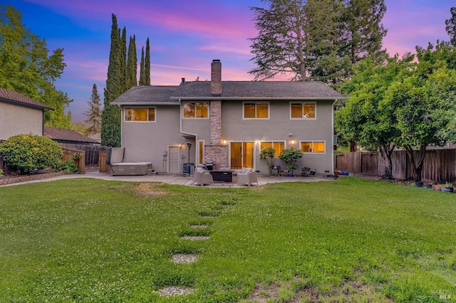 587 El Capitan Dr, Danville, CA 94526 - back of house at dusk featuring a patio area, a chimney, a hot tub, stucco siding, and an outdoor hangout area