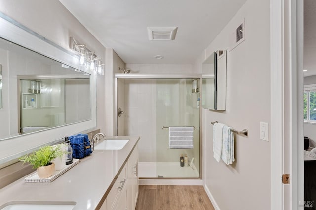 587 El Capitan Dr, Danville, CA 94526 - full bathroom featuring wood finished floors, double vanity, a shower stall, and baseboards