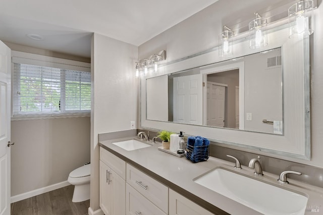 587 El Capitan Dr, Danville, CA 94526 - bathroom featuring toilet, double vanity, wood finished floors, and baseboards