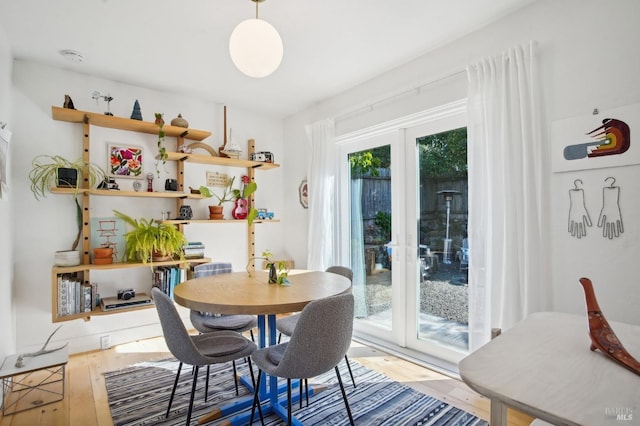 dining area with french doors and wood finished floors
