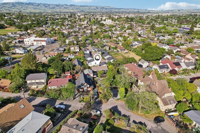 aerial overview of property's location featuring nearby suburban area and a mountain backdrop