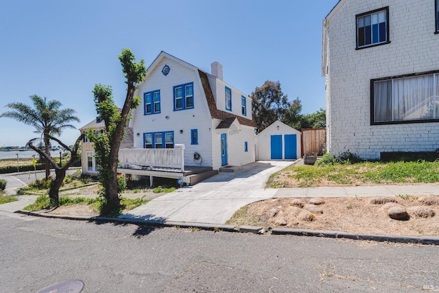 7 Sims Ave, Vallejo, CA 94590 - dutch colonial featuring concrete driveway, a gambrel roof, and a chimney
